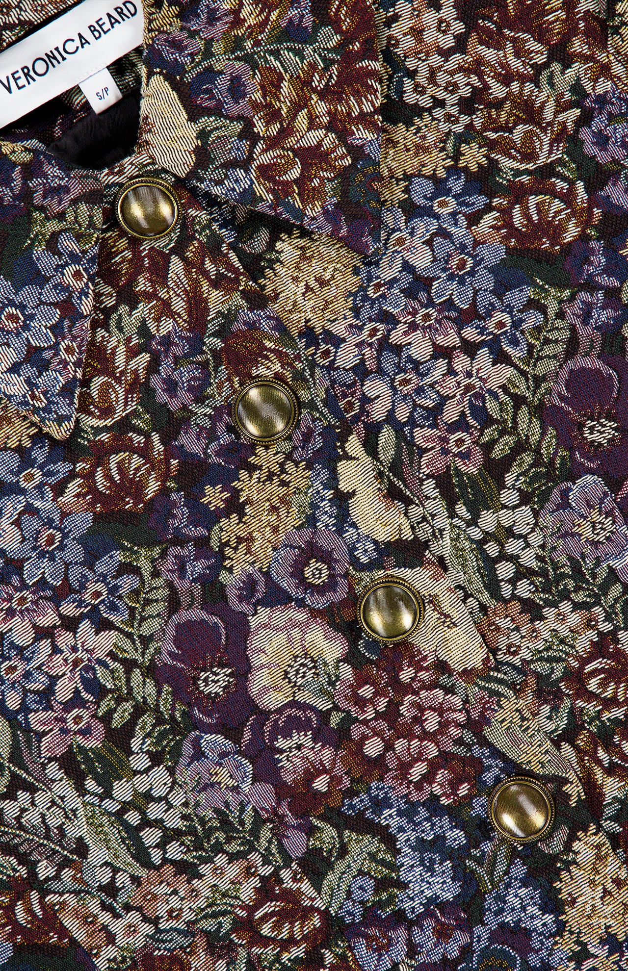 Close-up of a Veronica Beard Wilde Brocade Jacket with Removable Collar in slim fit floral brocade with a pointed collar and metallic gold buttons.