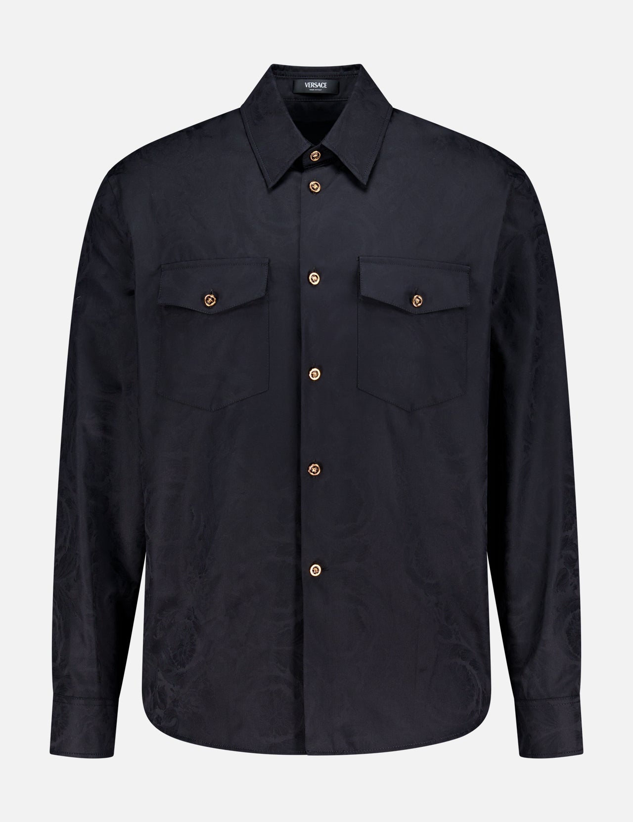 The VERSACE Baroque Jacquard Poplin Shirt features long sleeves, a black finish, two chest pockets, and signature Medusa buttons, shown against a plain white background.