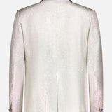 The image displays the back of the VERSACE Metallic Evening Tux Jacket, a light-colored lurex blazer with long sleeves, a center vent, and signature Medusa buttons on the cuffs for an elegant touch.