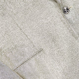 Close-up of the VERSACE Metallic Evening Tux Jacket featuring shiny silver lurex fabric, two jewel-like Medusa buttons, and a small pocket in view.