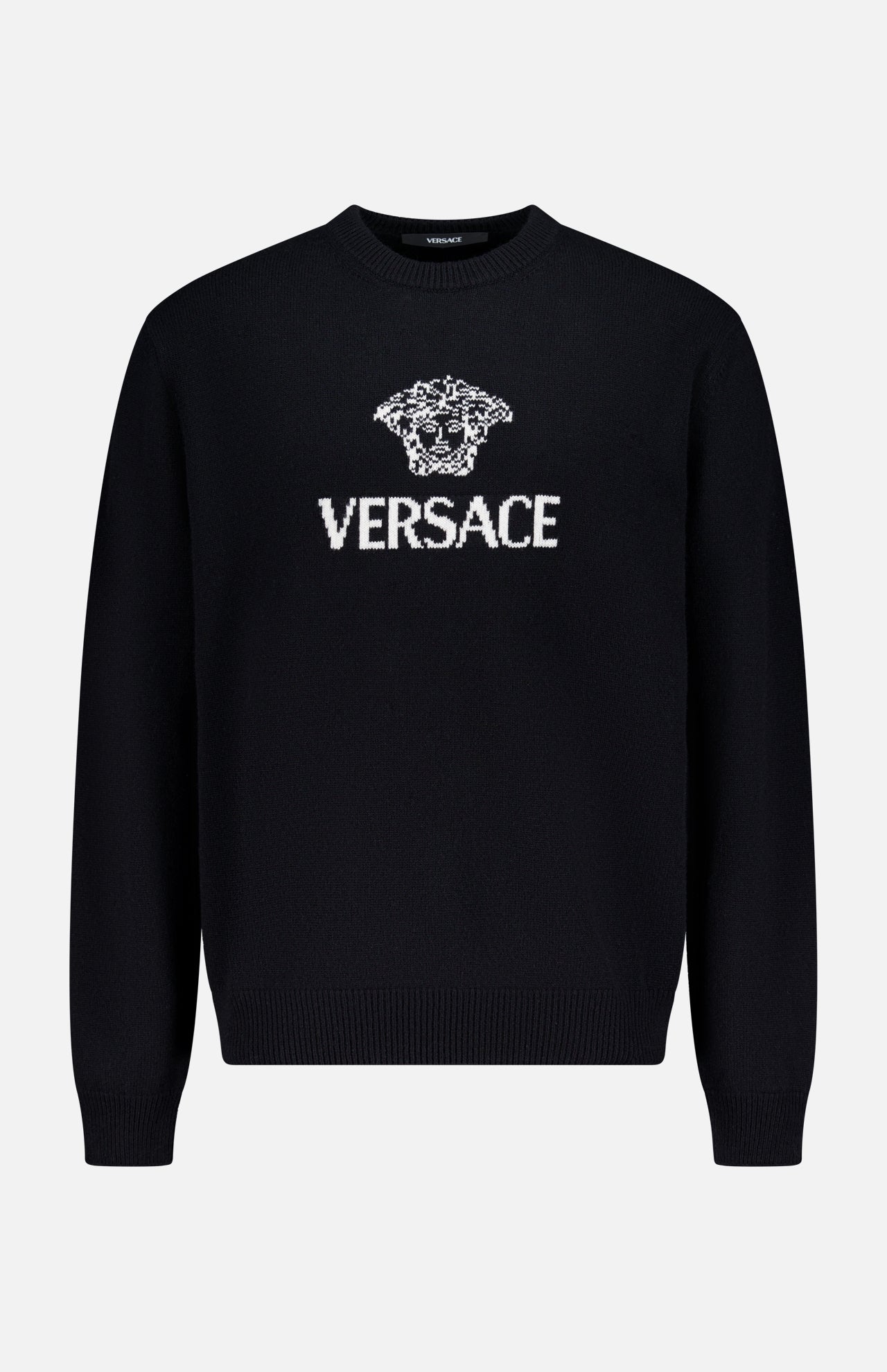 The Medusa Cashmere Knit Sweater by VERSACE is a black crewneck with long sleeves, showcasing the iconic Medusa logo and bold white VERSACE branding on the front—a standout in luxury Italian menswear.