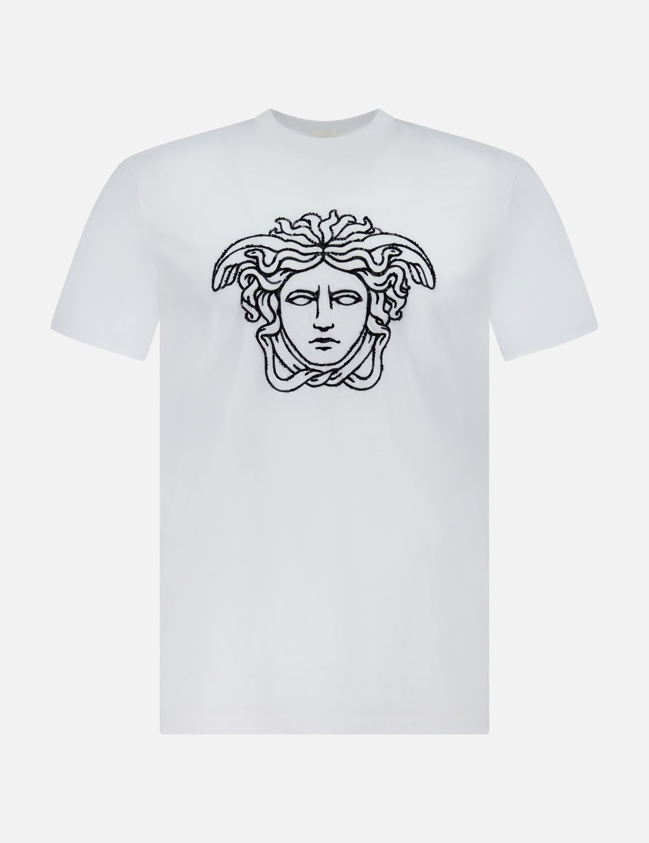 The VERSACE Cotton Jersey Medusa Embroidery T-Shirt showcases a black outlined Medusa head on the chest, set against a white background—a signature piece exemplifying luxury Italian fashion.