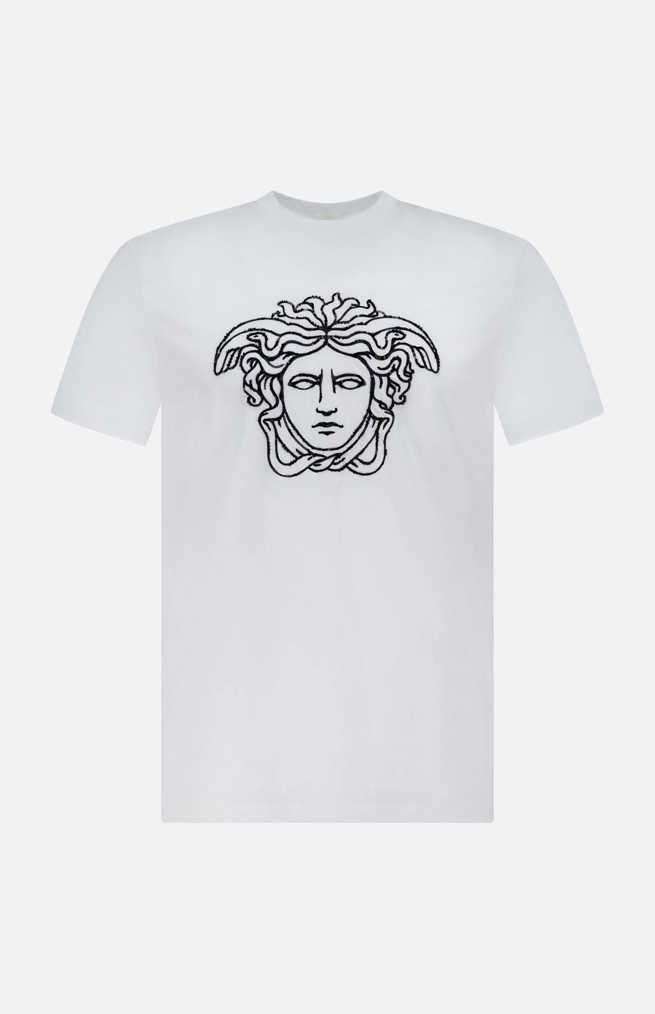 The VERSACE Cotton Jersey Medusa Embroidery T-Shirt showcases a black outlined Medusa head on the chest, set against a white background—a signature piece exemplifying luxury Italian fashion.