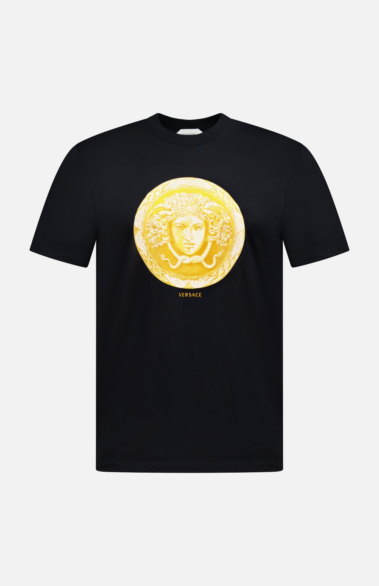 Introducing the VERSACE Cotton Medusa Coin Jersey T-Shirt: a black tee adorned with a striking gold Medusa coin emblem at the center and subtle yellow “VERSACE” lettering below—an iconic example of luxury Italian men’s fashion.