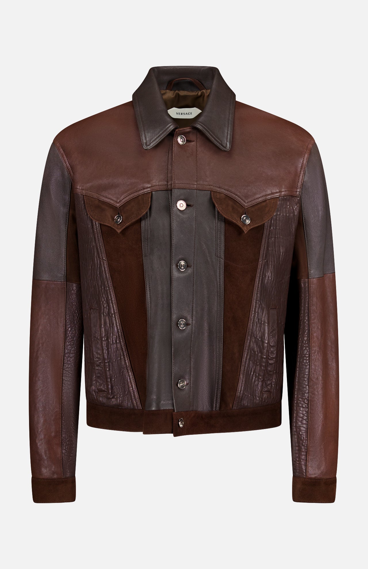 The VERSACE Leather Unit Mix Trucker Jacket is a men’s slim-fit piece crafted from brown leather and suede in varied shades, featuring a button-up front, pointed collar, flap chest pockets, and long sleeves for a polished look.