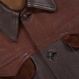 Close-up of the VERSACE Leather Unit Mix Trucker Jacket, highlighting its luxe leather and suede textures, black buttons, collar details, and an inner VERSACE label—a refined slim fit design for men.