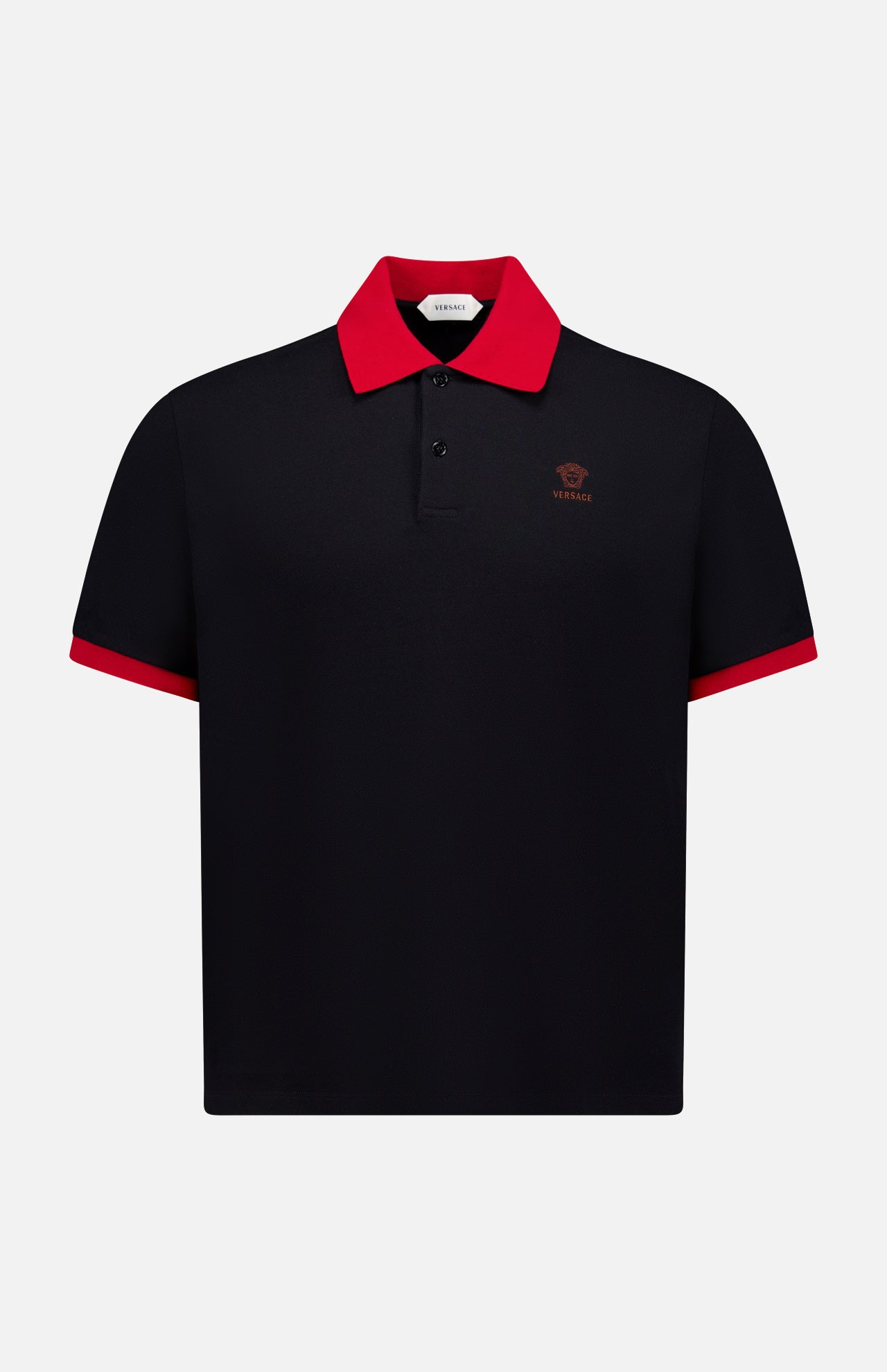 The VERSACE Medusa Logo Embroidery Piquet Polo Shirt is a black short-sleeve polo with a red collar, red sleeve trim, and a small red Medusa logo on the left chest—a statement of luxury Italian style.