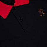 Close-up of the VERSACE Medusa Logo Embroidery Piquet Polo Shirt, showcasing its red collar, black buttons, and brown embroidered Medusa logo on the chest.