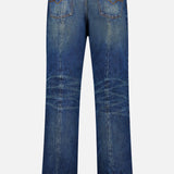 Back view of VERSACE Non-Stretch Dirty Wash Jeans in Dirty Blue with two back pockets, visible fading, crease details, frayed hems, and a black leather patch on the waistband.