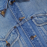 Close-up of the VERSACE Rigid Stone Washed Denim Jacket highlights its bold stitching, signature Medusa logo buttons, and a peek at the white collar label—exemplifying high-end Italian craftsmanship.