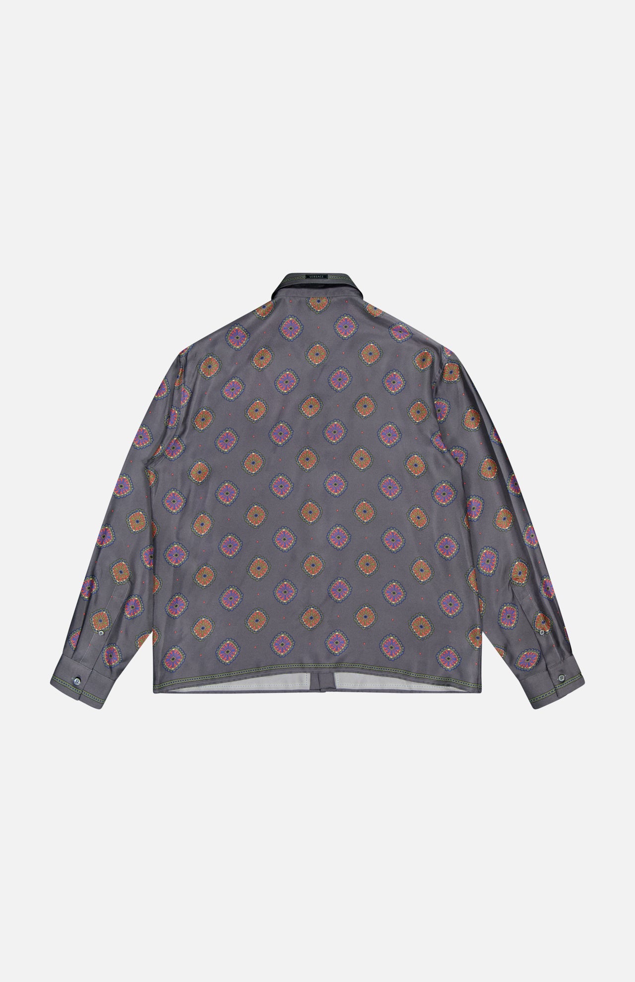 The VERSACE Silk Twill Print The Suitor Shirt is a gray long-sleeve button-up featuring orange, red, and purple geometric motifs. Shown flat from the back, this Italian menswear piece exudes signature luxury.