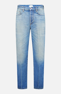Versace Stone Washed Rigid Jeans for men in light blue feature a high waist, button and zipper closure, five pockets, and a unique faded wash that gradually shifts to a darker blue at the hem. Displayed front-facing on a white background, these straight-leg designer jeans offer both style and sophistication.
