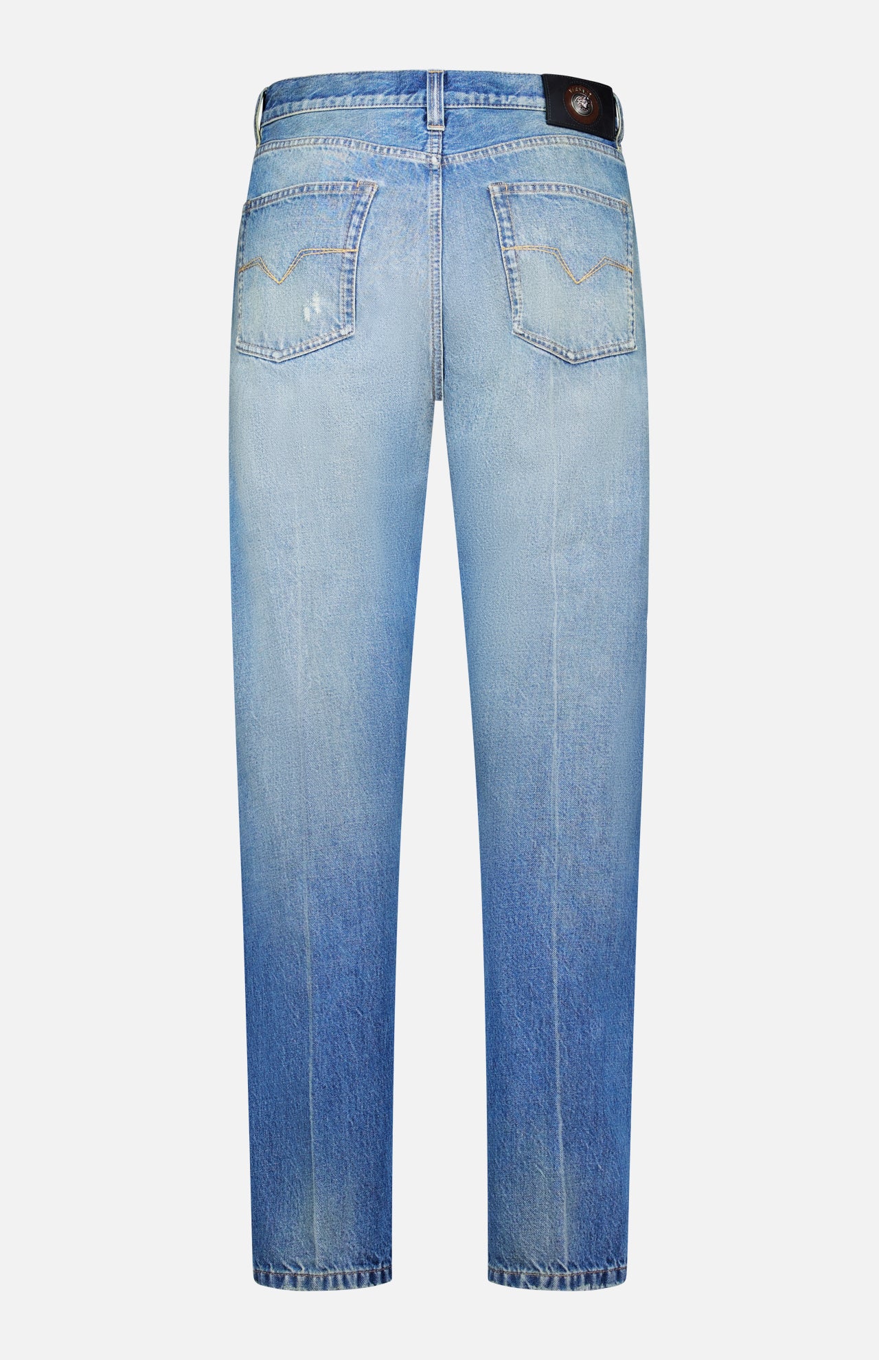 Back view of VERSACE’s Stone Washed Rigid Jeans in light blue, featuring straight-leg design with faded details, two back pockets, and a black leather patch on the waistband, highlighting the refined style of men’s designer denim.