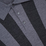 Close-up of a luxury VERSACE Sweater Rays Intarsia Knit Polo, featuring vertical dark and light gray stripes, a two-button placket, visible collar, and the partially shown Versace label at the top left.