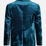 A teal VERSACE Viscose Silk Liquid Velvet Evening Jacket is shown from the back, featuring a smooth, slightly shiny texture and long sleeves with buttoned cuffs. This men’s luxury blazer captures the sophistication of Versace eveningwear through its refined detailing and opulent liquid velvet finish.