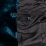 Close-up of the VERSACE Viscose Silk Liquid Velvet Evening Jacket’s inner lining, highlighting its lustrous dark brown fabric, buttoned interior pocket, and rich deep blue velvet detail on the left side—an exquisite feature that enhances this men’s luxury blazer.