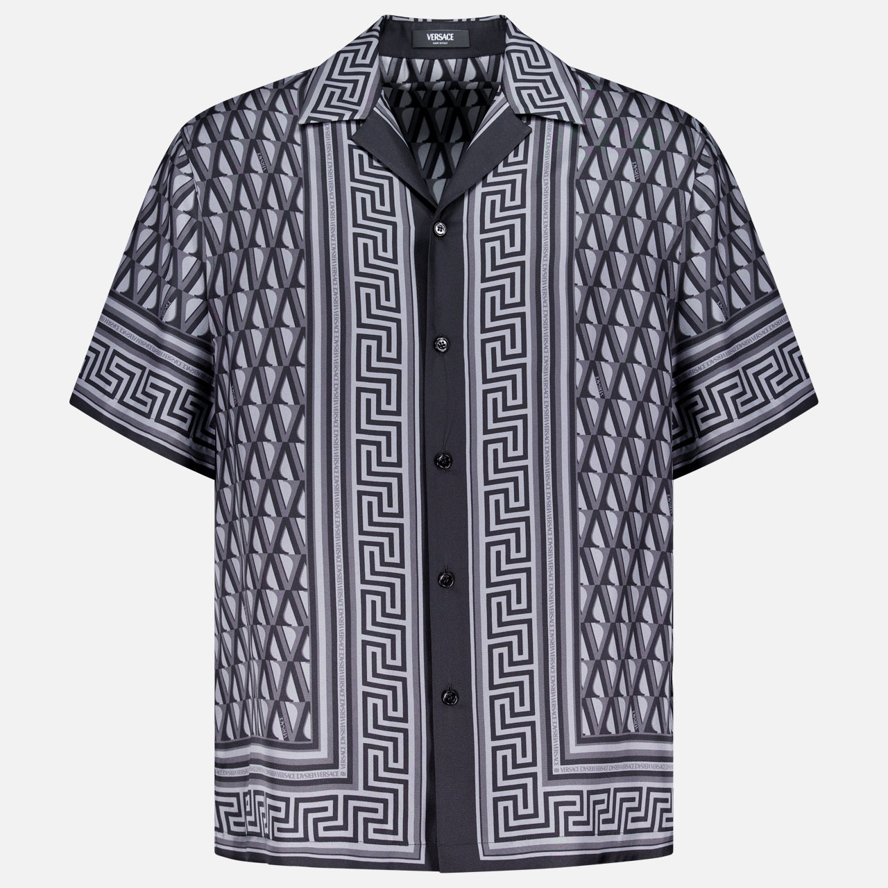 The VERSACE V Greca Print Silk Shirt is a slim-fit men’s short-sleeve shirt in black and gray with Greek key and diamond patterns, shown on a plain white background.