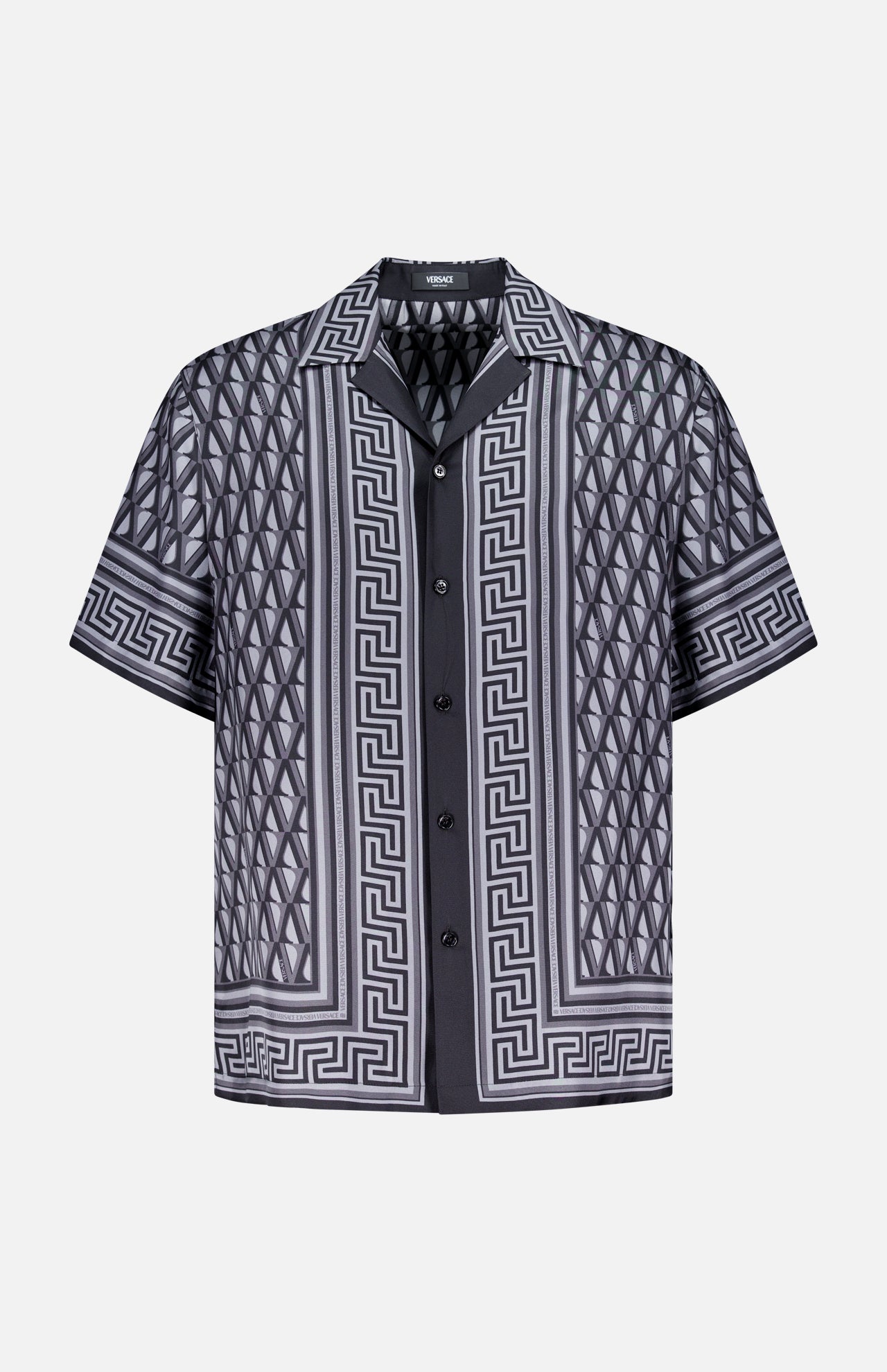 The VERSACE V Greca Print Silk Shirt is a slim-fit men’s short-sleeve shirt in black and gray with Greek key and diamond patterns, shown on a plain white background.