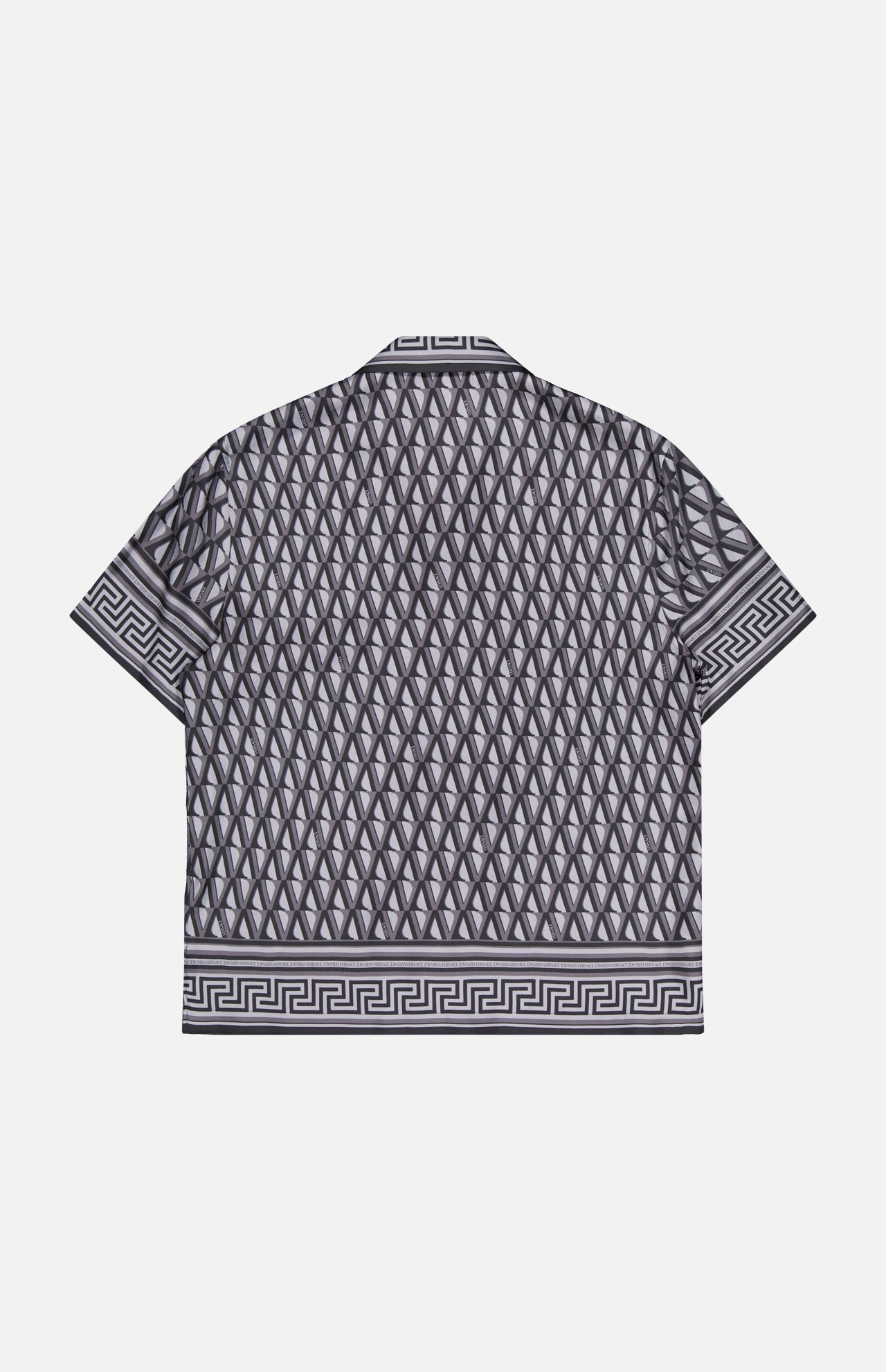 The VERSACE V Greca Print Silk Shirt is a short-sleeved, slim-fit men's shirt with a black and gray geometric diamond pattern and Greek key accents on the collar, sleeves, and hem, shown against a white background.