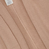 Close-up of a beige Cashmere Blend Poncho with Attached Scarf by WHITE + WARREN. The soft texture and seams are visible, showcasing the garment’s fine craftsmanship and neutral tone. Expertly crafted from a luxurious cashmere blend, this versatile piece is an ideal gift for women.