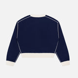 The Cashmere Blend Relaxed Crewneck Sweater by WHITE + WARREN is shown laid flat with the back facing up against a plain white background. This navy blue sweater features long sleeves, a crew neckline, and contrasting white cuffs, hem, collar, and piping details.