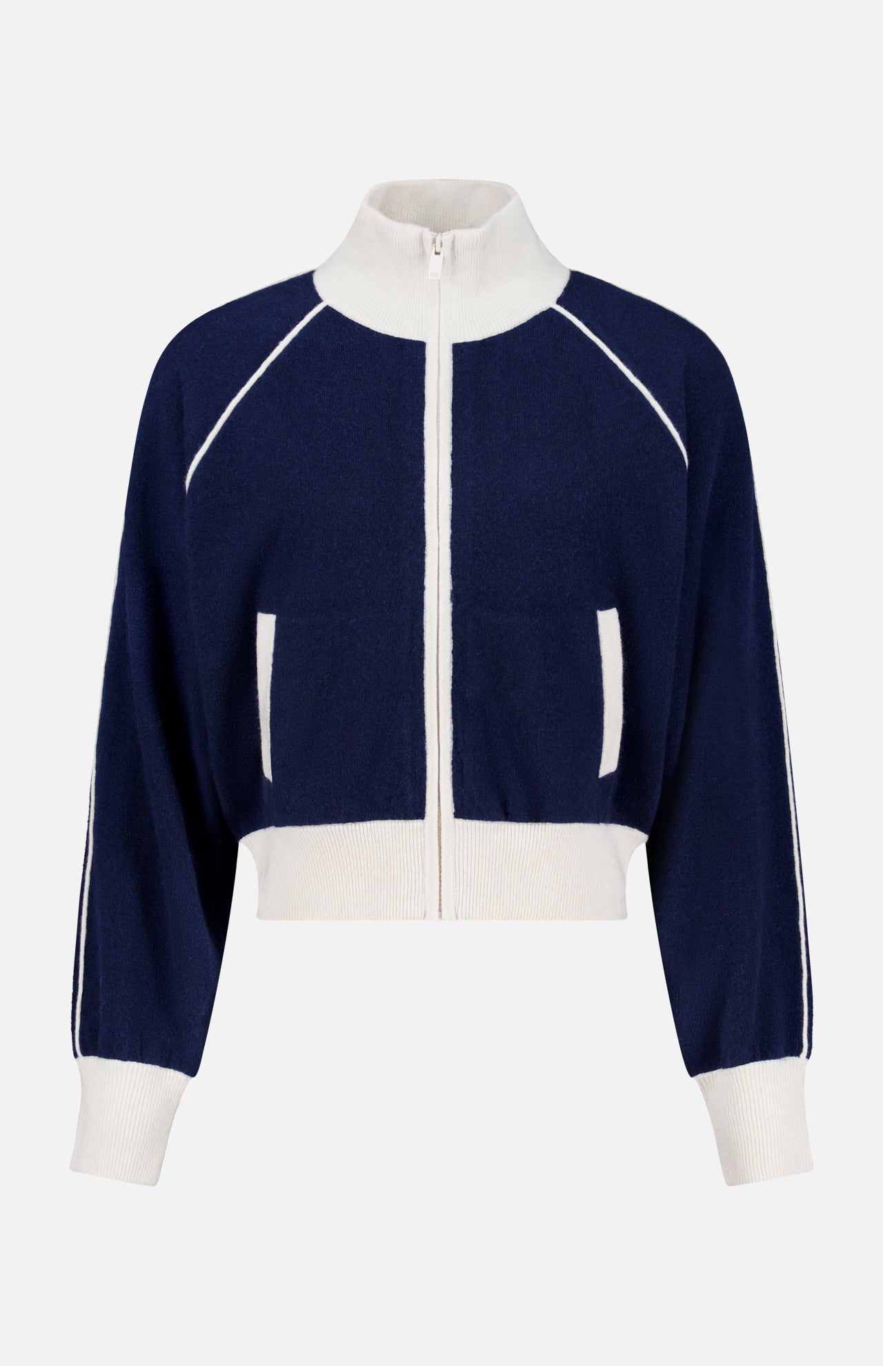 The WHITE + WARREN Cashmere Blend Track Jacket is shown on a plain background, featuring a navy design with white trim, a high collar, white ribbed cuffs and hem, and distinctive white vertical stripes along the sleeves and pockets.