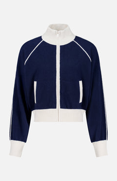 The WHITE + WARREN Cashmere Blend Track Jacket is shown on a plain background, featuring a navy design with white trim, a high collar, white ribbed cuffs and hem, and distinctive white vertical stripes along the sleeves and pockets.