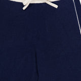Close-up of the WHITE + WARREN Cashmere Blend Track Pants in navy, featuring a white ribbed waistband, drawstring waist, and a thin white stripe running down the side—perfect knit bottoms for both comfort and style.
