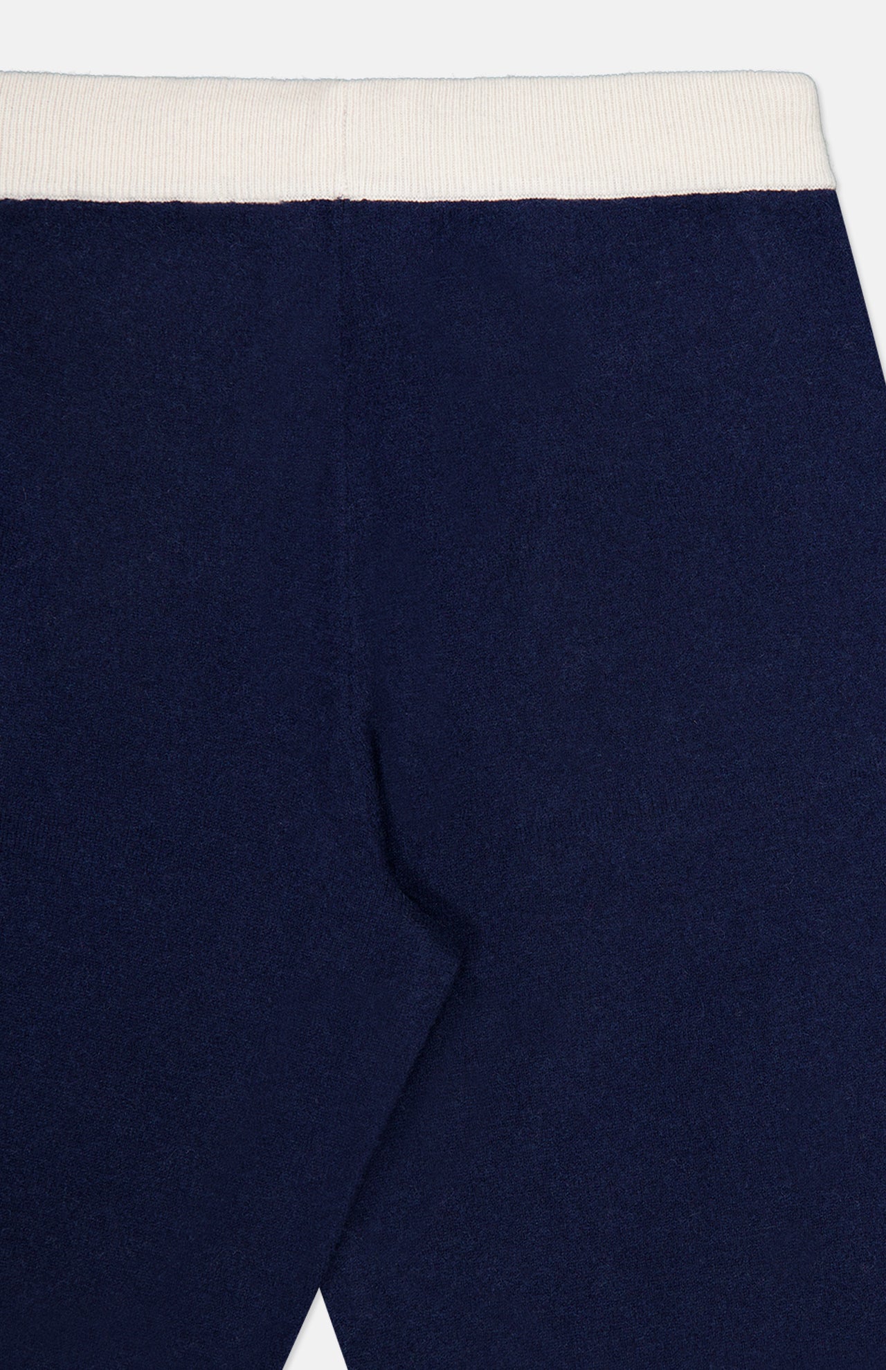 Close-up of the WHITE + WARREN Cashmere Blend Track Pants in navy blue, featuring a white elastic waistband, upper back seam detail, and a comfortable drawstring waist.