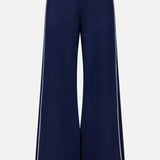 The Cashmere Blend Track Pants by WHITE + WARREN are wide-leg navy knit bottoms with a relaxed fit, designed with a white drawstring waist and vertical white stripes along the outer sides. Made from a soft, comfortable fabric blend including cashmere.