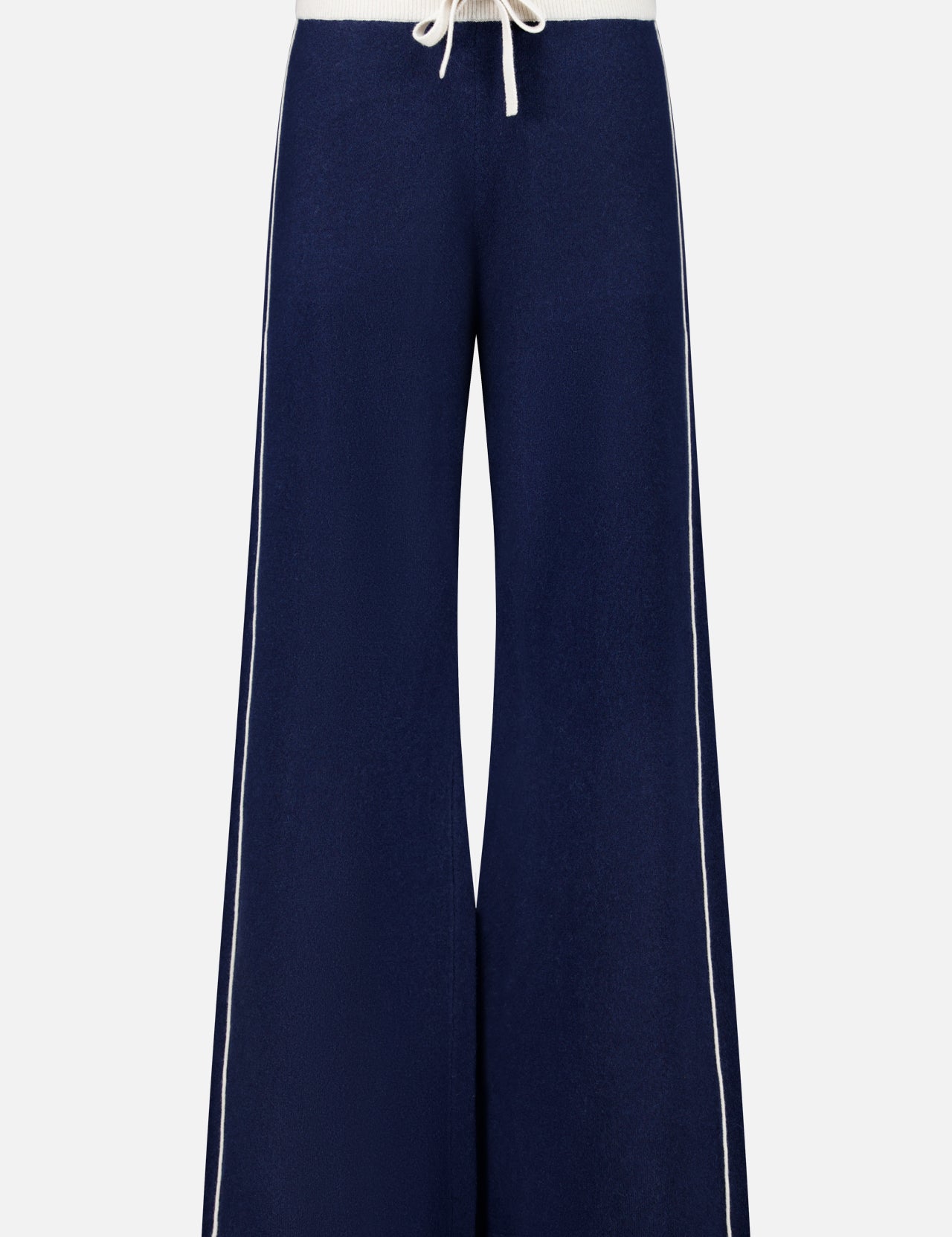 The Cashmere Blend Track Pants by WHITE + WARREN are wide-leg navy knit bottoms with a relaxed fit, designed with a white drawstring waist and vertical white stripes along the outer sides. Made from a soft, comfortable fabric blend including cashmere.