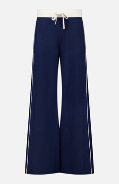 The Cashmere Blend Track Pants by WHITE + WARREN are wide-leg navy knit bottoms with a relaxed fit, designed with a white drawstring waist and vertical white stripes along the outer sides. Made from a soft, comfortable fabric blend including cashmere.