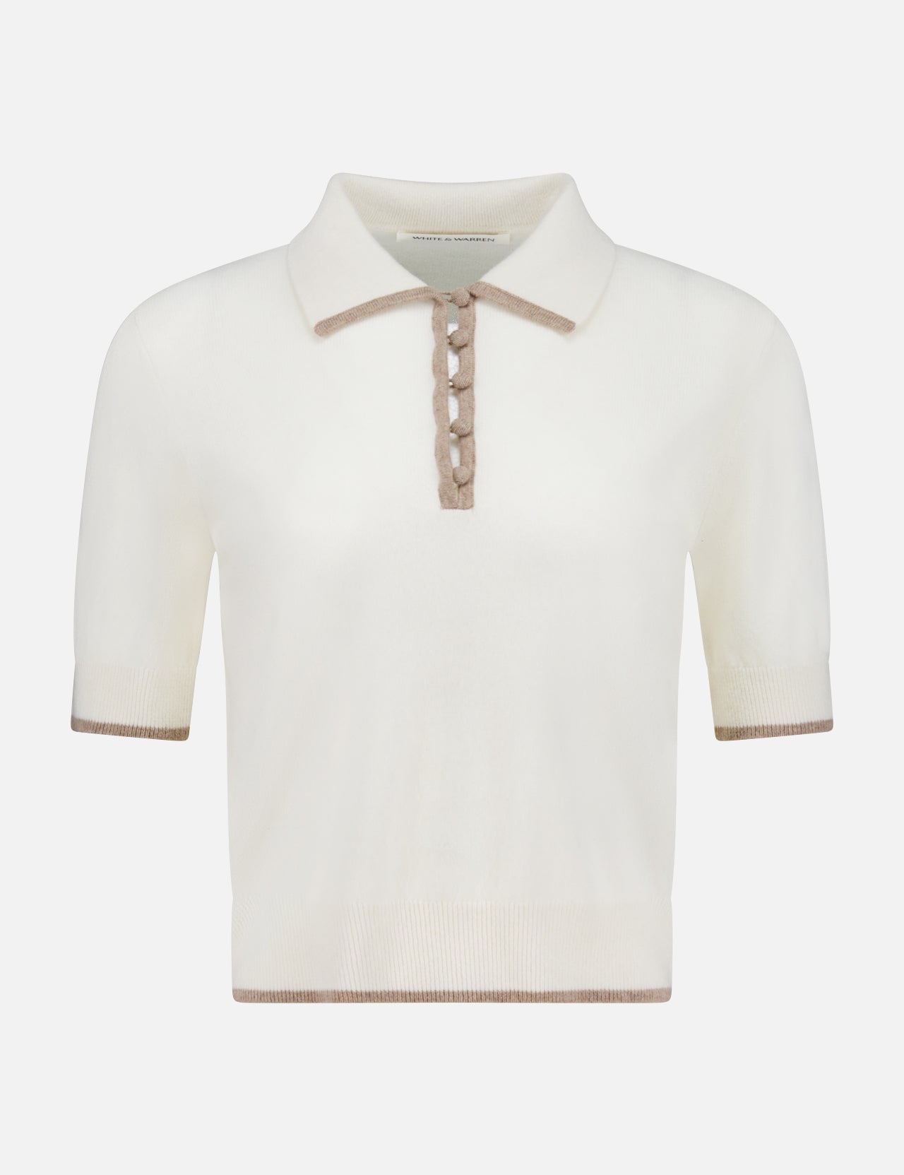 The WHITE + WARREN Cashmere Button Polo Shirt is a ladies’ cropped, short-sleeve off-white sweater with a beige collar, button placket, and trim on the sleeves and hem. It features a classic, minimalist design.