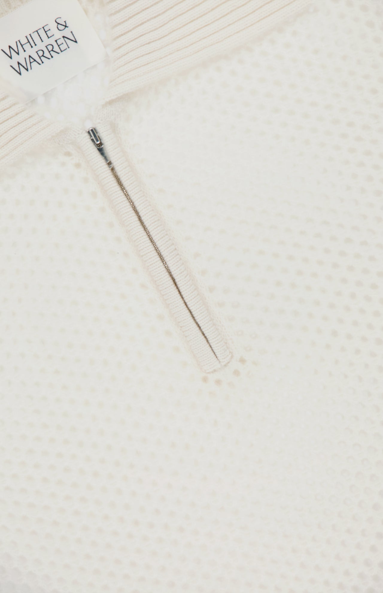 Close-up of the WHITE + WARREN Cashmere Mesh Polo Shirt, featuring a zippered neckline and ribbed collar that highlight its refined mesh texture.