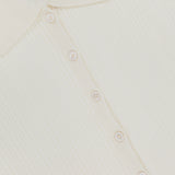 Close-up of the WHITE + WARREN Cashmere Pointelle Shirt in cream, featuring a collar, six small front buttons, and delicate pointelle detailing.