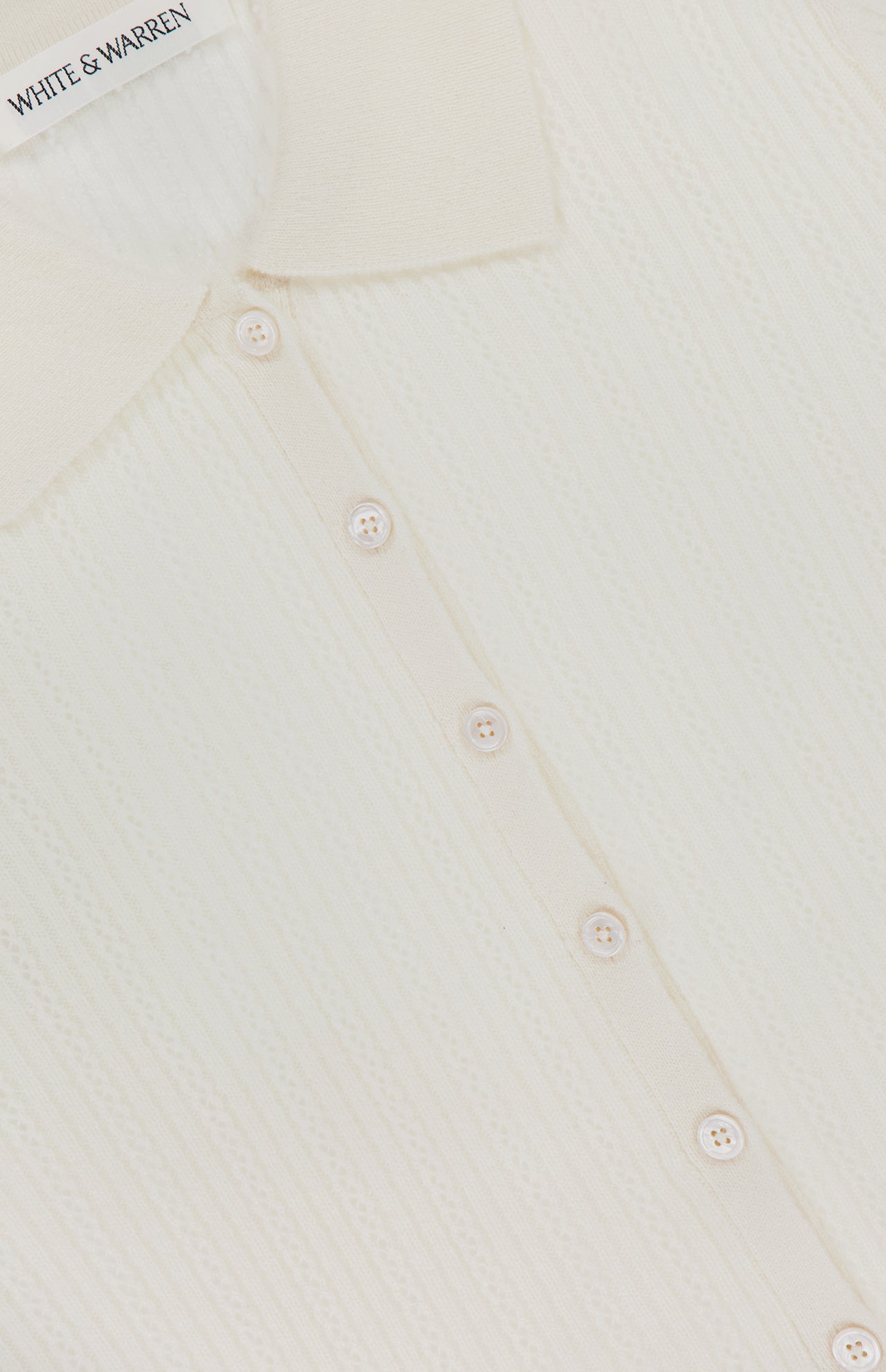 Close-up of the WHITE + WARREN Cashmere Pointelle Shirt in cream, featuring a collar, six small front buttons, and delicate pointelle detailing.