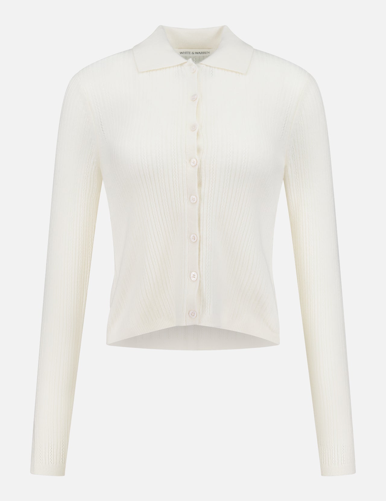 The WHITE + WARREN Cashmere Pointelle Shirt is a long-sleeve, ribbed off-white cardigan with a collar, front buttons, and subtle pointelle detailing, displayed on a plain white background.