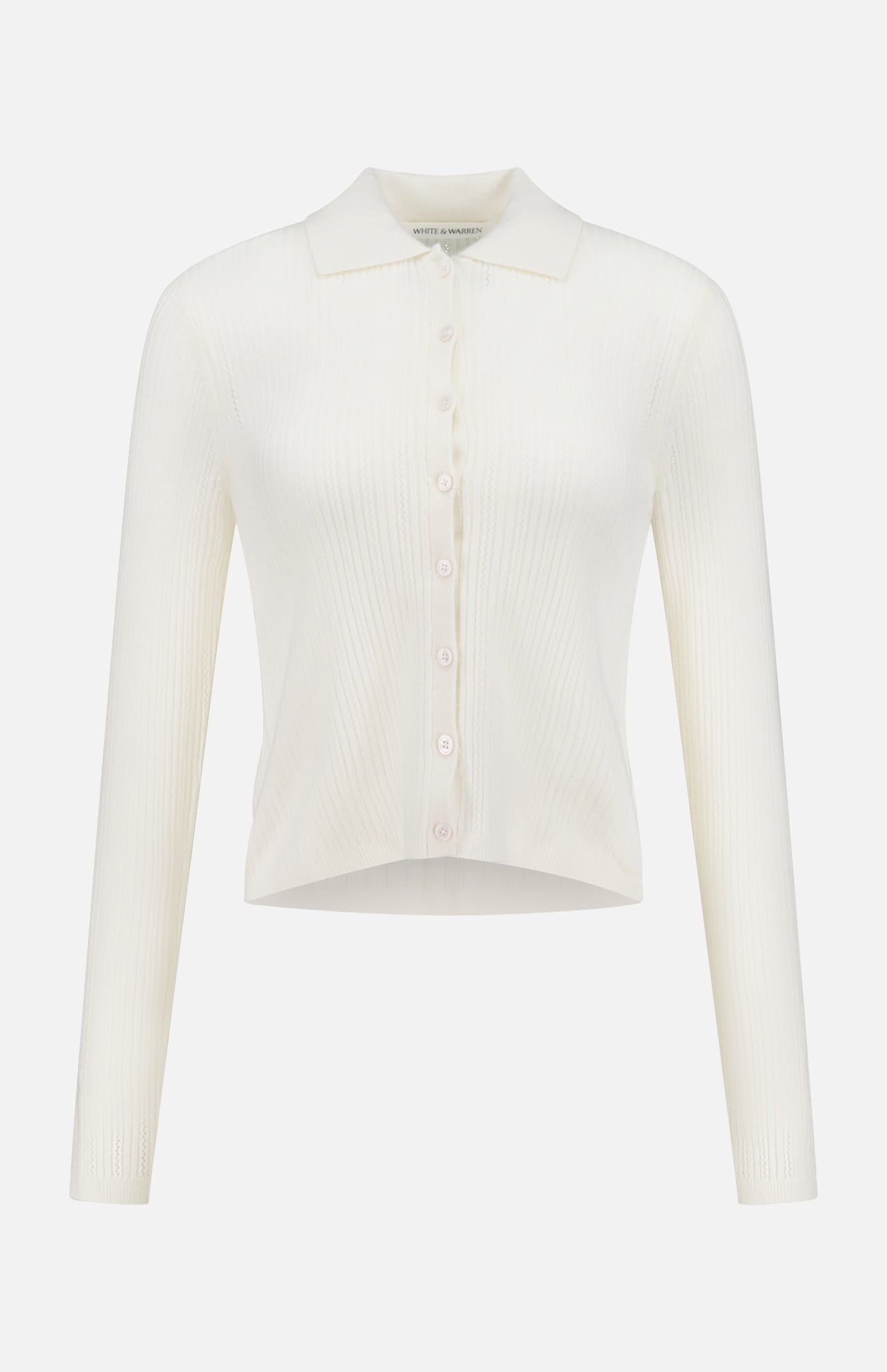 The WHITE + WARREN Cashmere Pointelle Shirt is a long-sleeve, ribbed off-white cardigan with a collar, front buttons, and subtle pointelle detailing, displayed on a plain white background.