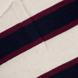 Close-up of the Cashmere Rugby Long Sleeve Polo Shirt by WHITE + WARREN, featuring cream, navy blue, and burgundy horizontal stripes inspired by the rugby trend. The shirt is finished with a cream collar and a WHITE + WARREN label.