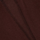 Close-up of the dark brown Cashmere Trapeze Cardigan fabric with a visible seam and a white label reading WHITE + WARREN in black text sewn into the top left corner.