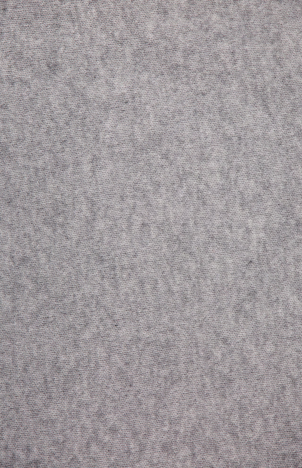 Close-up of the WHITE + WARREN Cashmere Travel Wrap in light grey, showcasing its soft, textured surface with subtle mottling and gentle variations in shading, reminiscent of a cozy blanket or luxurious cashmere. No distinct patterns or objects are visible.