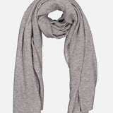 A luxurious light gray Cashmere Travel Wrap by WHITE + WARREN is softly folded in a loop with both ends draping down, set against a plain white background—ideal as a cozy blanket or an elegant accessory for every journey.