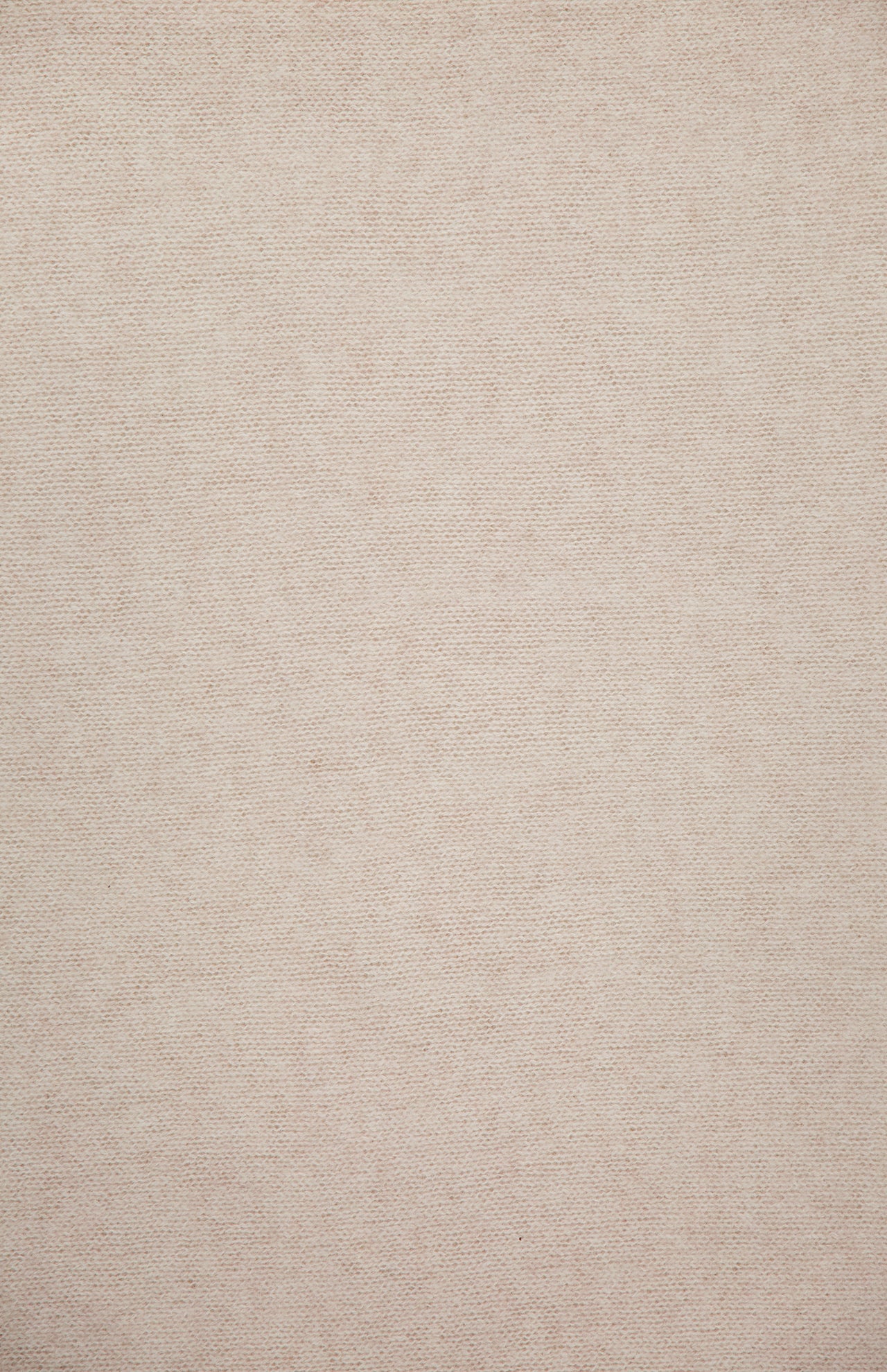 A close-up of the WHITE + WARREN Cashmere Travel Wrap showcases its plain, beige cashmere fabric with a subtle, fine texture. The surface appears smooth and uniform, featuring no visible patterns or designs.