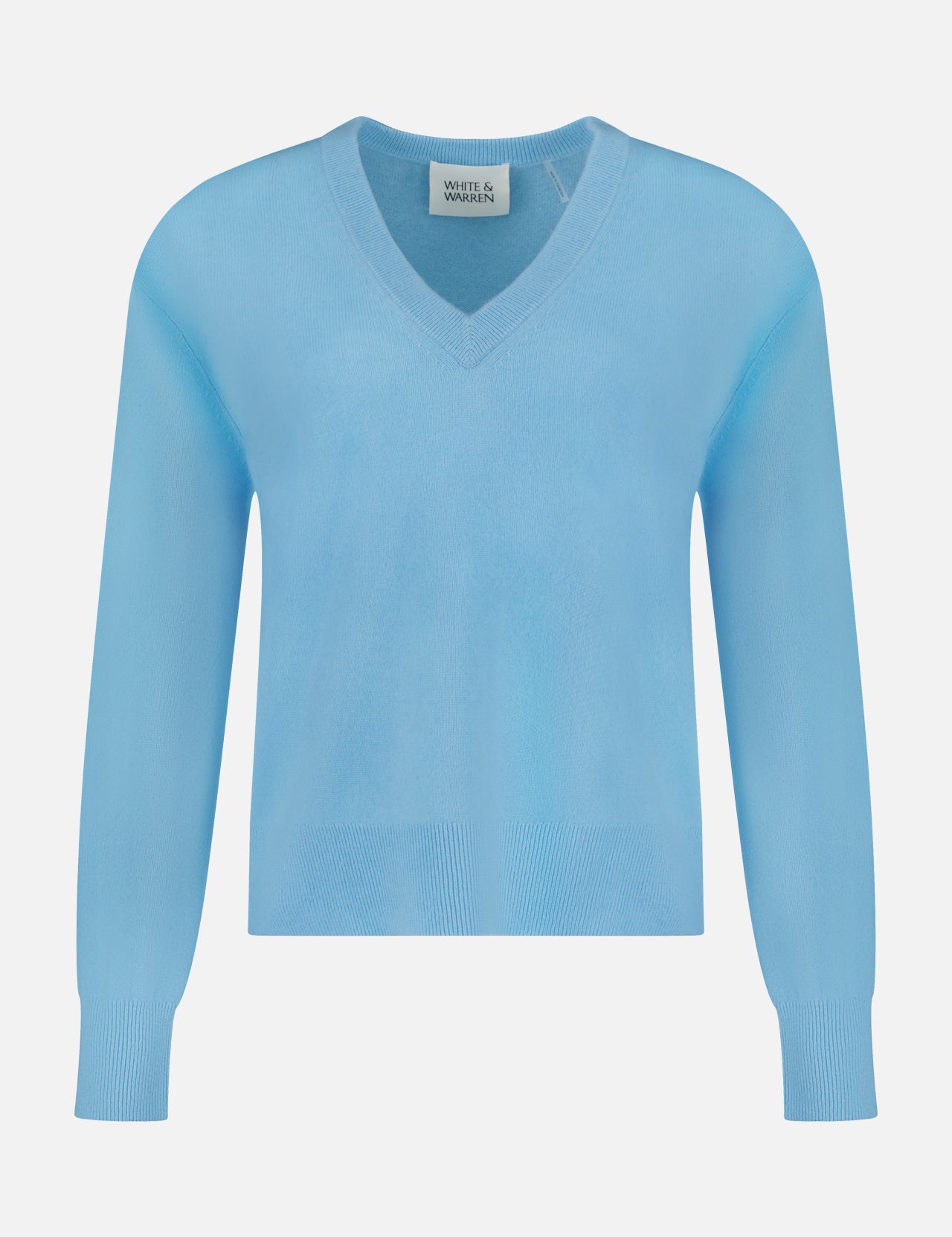 The WHITE + WARREN Cashmere V-neck Sweater is shown in light blue, featuring long sleeves with ribbed cuffs and hem, displayed against a plain white background. This sweater offers luxurious softness and classic style, making it a timeless addition to your wardrobe.