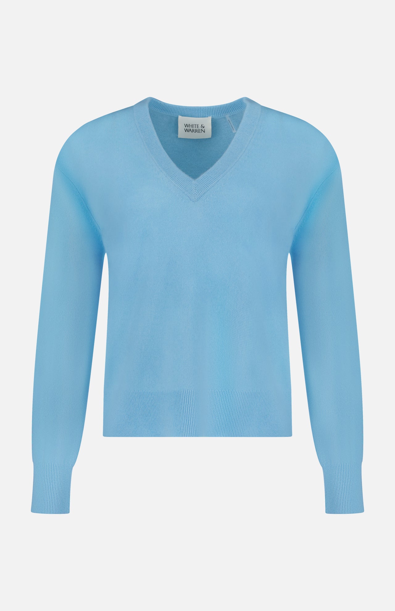 The WHITE + WARREN Cashmere V-neck Sweater is shown in light blue, featuring long sleeves with ribbed cuffs and hem, displayed against a plain white background. This sweater offers luxurious softness and classic style, making it a timeless addition to your wardrobe.