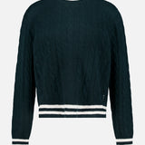 The WHITE + WARREN Cashmere Varsity Cable Crewneck Sweater in dark green features a classic cable-knit design and white ribbed trim on the collar, cuffs, and hem, shown against a plain white background.