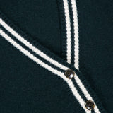 Close-up of a dark green White + Warren Cashmere Varsity Cardigan with white double-stripe trim along the V-neck and front placket.