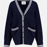 The WHITE + WARREN Cashmere Varsity Cardigan is a navy boyfriend-style piece with white stripes on the collar, cuffs, hem, and pockets. It features a V-neck, front buttons, two front pockets, and “White + Warren” labeling.