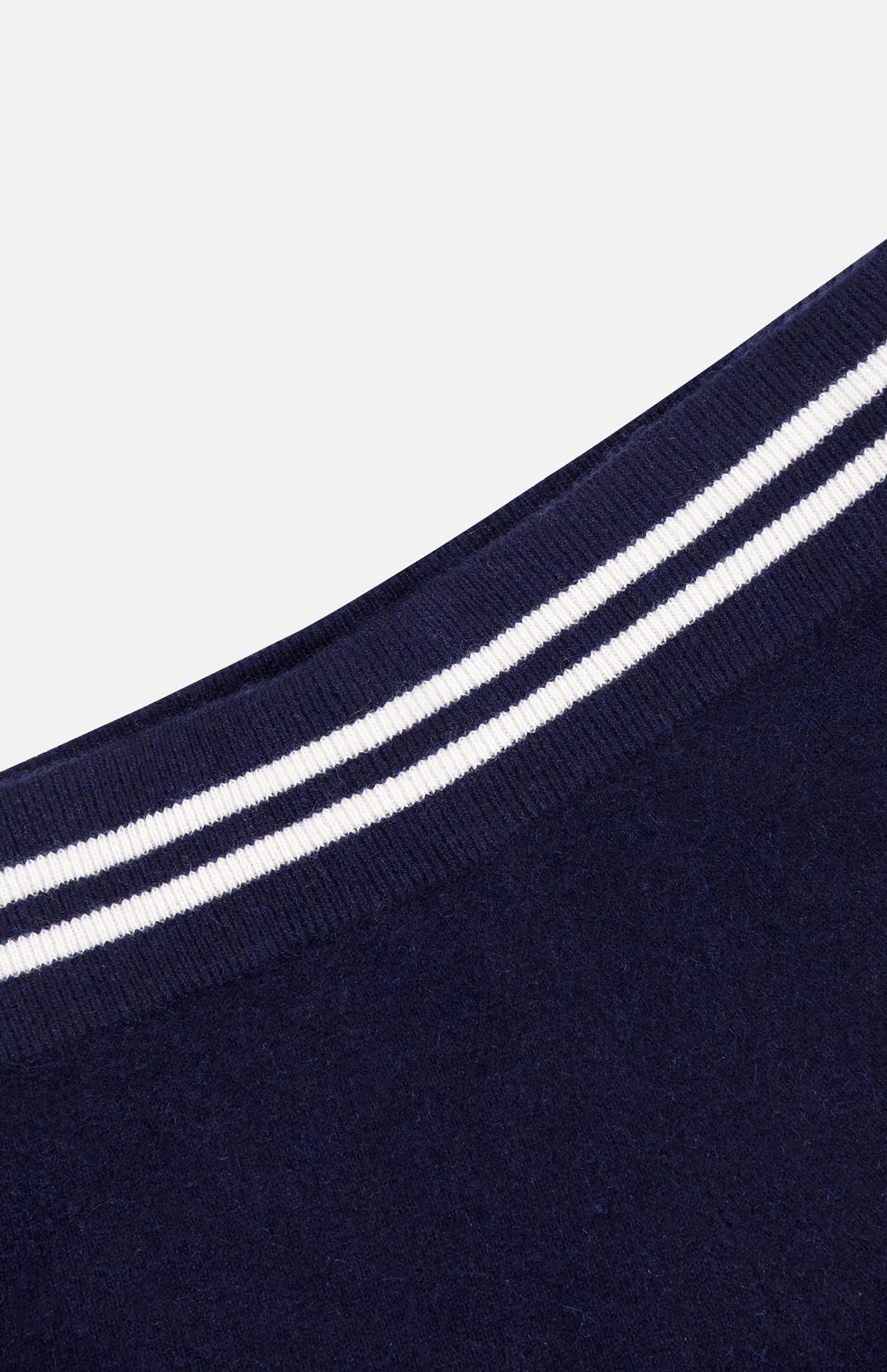 Close-up of WHITE + WARREN Cashmere Varsity Shorts in navy, with rounded edges and two parallel white stripes along the border, shown against a plain white background.