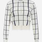 The WHITE + WARREN Cashmere Windowpane Cardigan Sweater is crafted from luxurious off-white cashmere, featuring long sleeves, a navy blue windowpane pattern, and white buttons down the front.